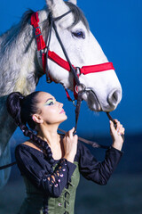 Charming European lady posing with a majestic white horse in an open field, symbolizing freedom, calmness, and connection with nature.