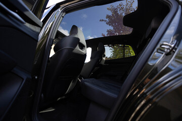 Panoramic glass sun roof in the modern electric car. Clean sunroof and view at the sky from the...