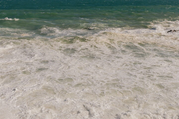 Natural marine background of stormy sea surface, powerful waves and white foam