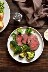 Juicy grilled beef steak served with roasted broccoli