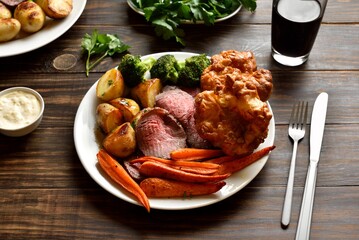 Sunday Roast with roasted beef, carrots, crispy potato, broccoli