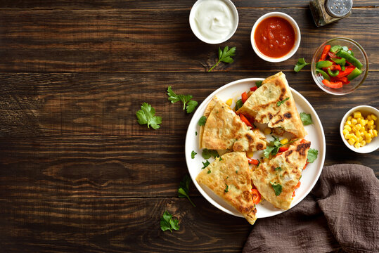 Quesadilla with fresh vegetables on wooden table - Powered by Adobe