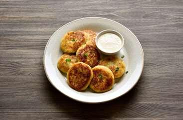 Potato pancakes made from mashed potato and minced fish served with sauce