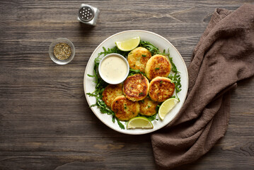 Homemade potato pancakes made from mashed potato and minced fish served with dipping sauce