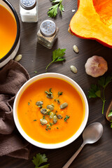 Creamy pumpkin soup garnished with seeds and thyme