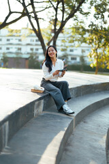 Young woman relaxing in park using smartphone