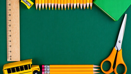 A "back to school" frame made from colorful pencils, a ruler, scissors, and a toy school bus on a green background.