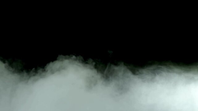 A layer of white fog or smoke effect against a black background for compositing and visual effects use