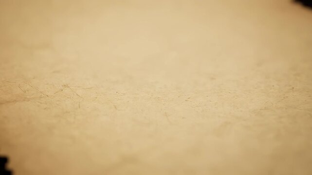Old, weathered paper background with a textured look in a soft shade of yellow. A vintage scroll or document with a distressed, aged appearance, slowly turning against a dark backdrop