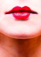 Close-up of a person's lips with bright red lipstick