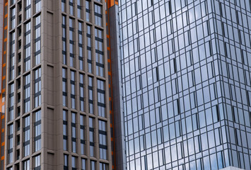 Fototapeta premium Modern Skyscraper Facades with Blue Glass and Concrete Grid