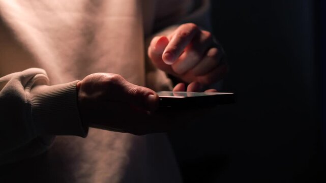 A person scrolling through a news feed on a touchscreen mobile phone.
Using social media on a phone.
Entering a PIN code on a touchscreen smartphone.