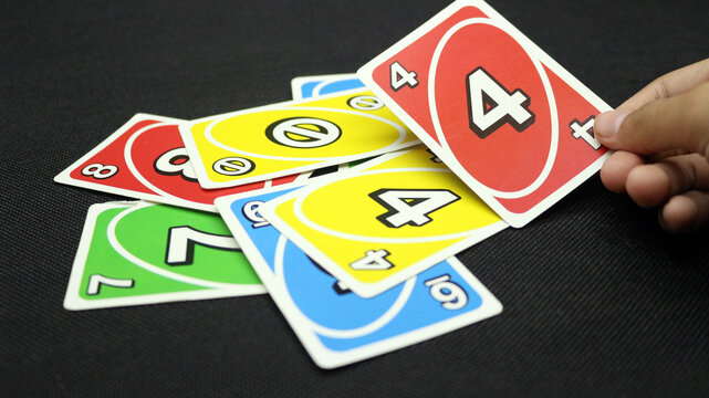Uno cards scattered on a black background