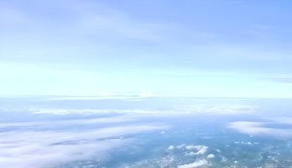 a view of a bright blue sky decorated with thin white clouds