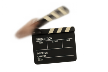 Hand slamming clapperboard for film production, showing action cut during cinematic movie scene
