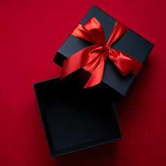 An open, empty black gift box with a large red ribbon, perfect for a dramatic and luxurious product presentation.
