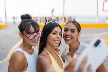 Mexican women friends taking selfie during vacation in puerto vallarta