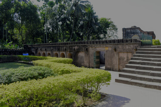 pavilion with red arches in 'azimunnisa begum' cemetery complex surrounded by ornate gardens and trees at murshidabad