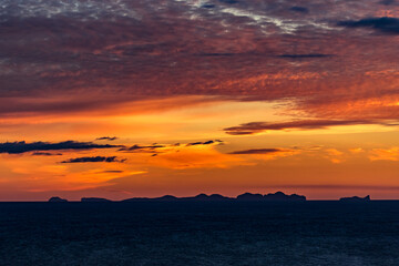 Stunningly beautiful sunset over the ocean as seen from the cape cliffs near the lighthouse of Vik, small city in Southern Iceland, travel tourist destination and sightseeing