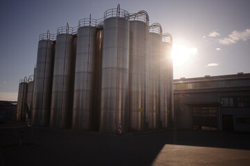 Industrial Silos with Bright Sun Flare