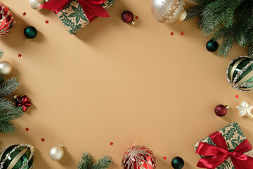 Overhead view of a holiday composition with gifts, fir branches, and baubles. Merry Christmas and...