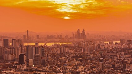 Vibrant orange sunset over a dense cityscape