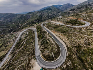 A winding road in the mountains, captured with a drone.