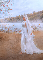 art photo real person fantasy young elf woman beauty face walking by river bank water sea, autumn nature fairy girl fashion model long blonde ash hair white dress fly in wind. myth faun pixie lady