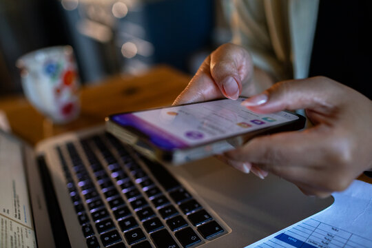 Focused adult using smartphone for mobile banking at home