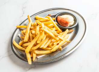 Golden french fries with tasty dipping sauce ready to enjoy on a modern marble table providing a delicious and satisfying meal