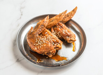 Craving crispy fried chicken wings drizzled with delicious sauce and sprinkled with sesame seeds for an authentic culinary experience