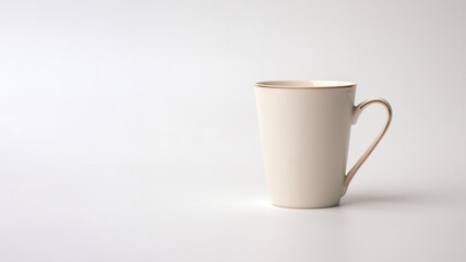A white cup of simple conical shape with a gold rim along the handle and top on a white background. Copy space.