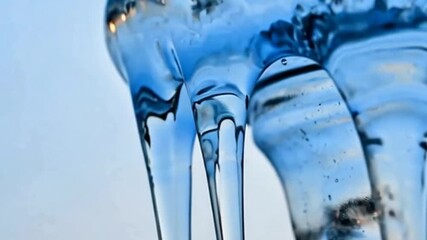 Dynamic fluid motion of vibrant blue liquid dripping with elegance, perfect for showcasing viscosity and captivating scientific visuals or skincare product demonstrations