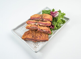 Golden crispy cordon bleu on a stylish plate with fresh salad, perfect for lunch menus or culinary promotions, appetizing and delicious