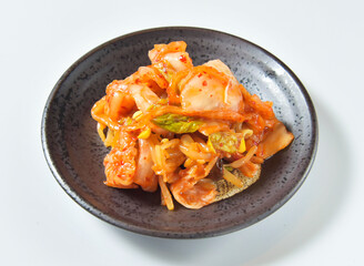 Vibrant authentic Korean kimchi in a rustic black bowl, bursting with spicy flavor, perfect for culinary projects