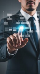 Man in Suit Interacting with Flowchart on Transparent Screen