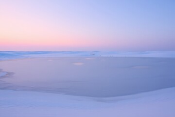 Serene arctic landscape under a soft pastel sunrise