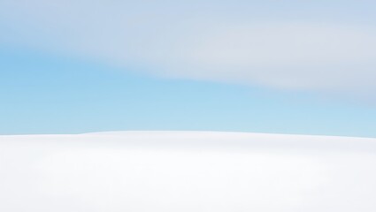 Vast snowy landscape under a pale blue sky