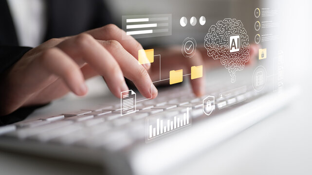 Close-up of hands engaging with a keyboard, showcasing digital icons that symbolize artificial intelligence and data analysis in a contemporary workspace environment. Gantry