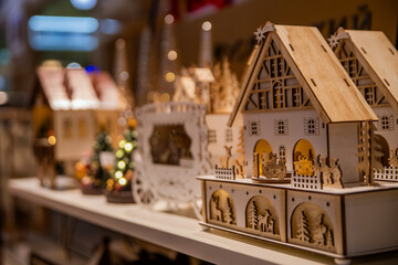 Wooden christmas decoration house with miniature illuminated scene inside