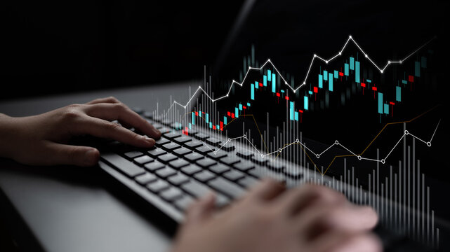 A close-up view of hands on a keyboard engaged in analyzing stock market trends, with dynamic financial graphs displayed on a screen, highlighting trading and investment strategies. Scalp