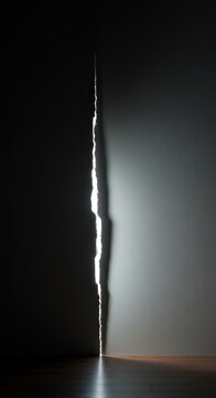A glaring gap in a rigid wall structure, illustrating a flaw, weakness, or an easy route for evasion and exploiting regulatory inconsistencies ,flaw ,finding ,obstacle