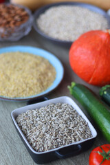 Assortment of various healthy fruits, vegetables, grains and legumes. Selective focus, wooden background.