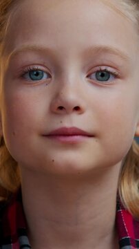 Portrait calm Caucasian cute girl child kid daughter looking at camera smiling without teeth schoolgirl adorable baby healthy face look in evening home apartment pediatric medicine childhood custody