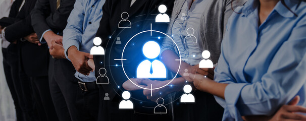 A group of diverse professionals standing together in a corporate setting, emphasizing teamwork and digital interaction through user icons in a focused interface. Trope