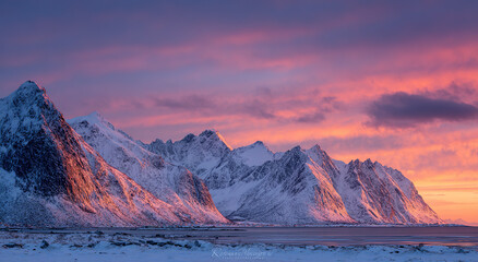 Snow-capped mountain range under vibrant aurora borealis at dusk; natural landscape concept.