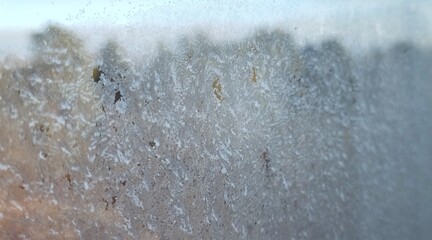 frost on frozen window freezing icy glass texture closeup view abstract christmas winter nature pattern background