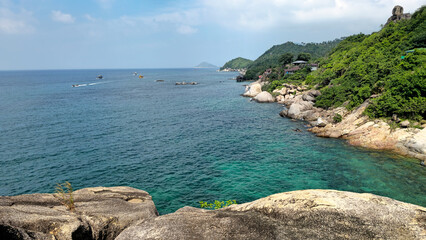 Tropical panoramic view showing blue sea, rocky shore and green hills, Island Ko Tao, Surat Thani, Thailand, Southeast Asia.