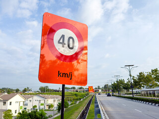 A roadside speed limit sign displaying the number 40, indicating a maximum speed of 40 km/h on a public road.