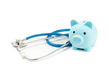 Medical costs, financial concept, health insurance. Stethoscope over dollar bills. Money and piggy bank. Medical care. Health care financial checkup or saving for medical insurance costs concept.